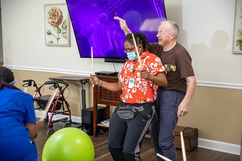 elder care facility residents enjoying fun activity of drum circle