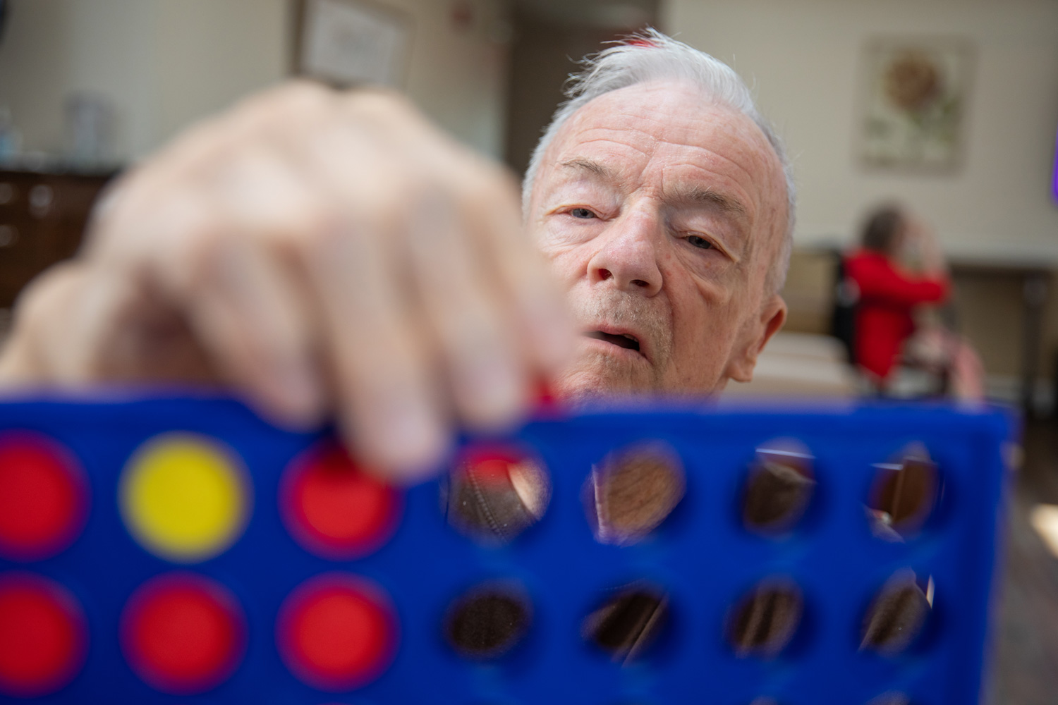 elderly care resident playing a game of link 4