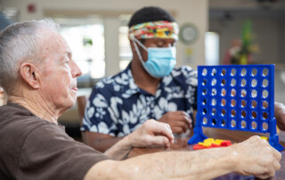 resident playing game with careworker
